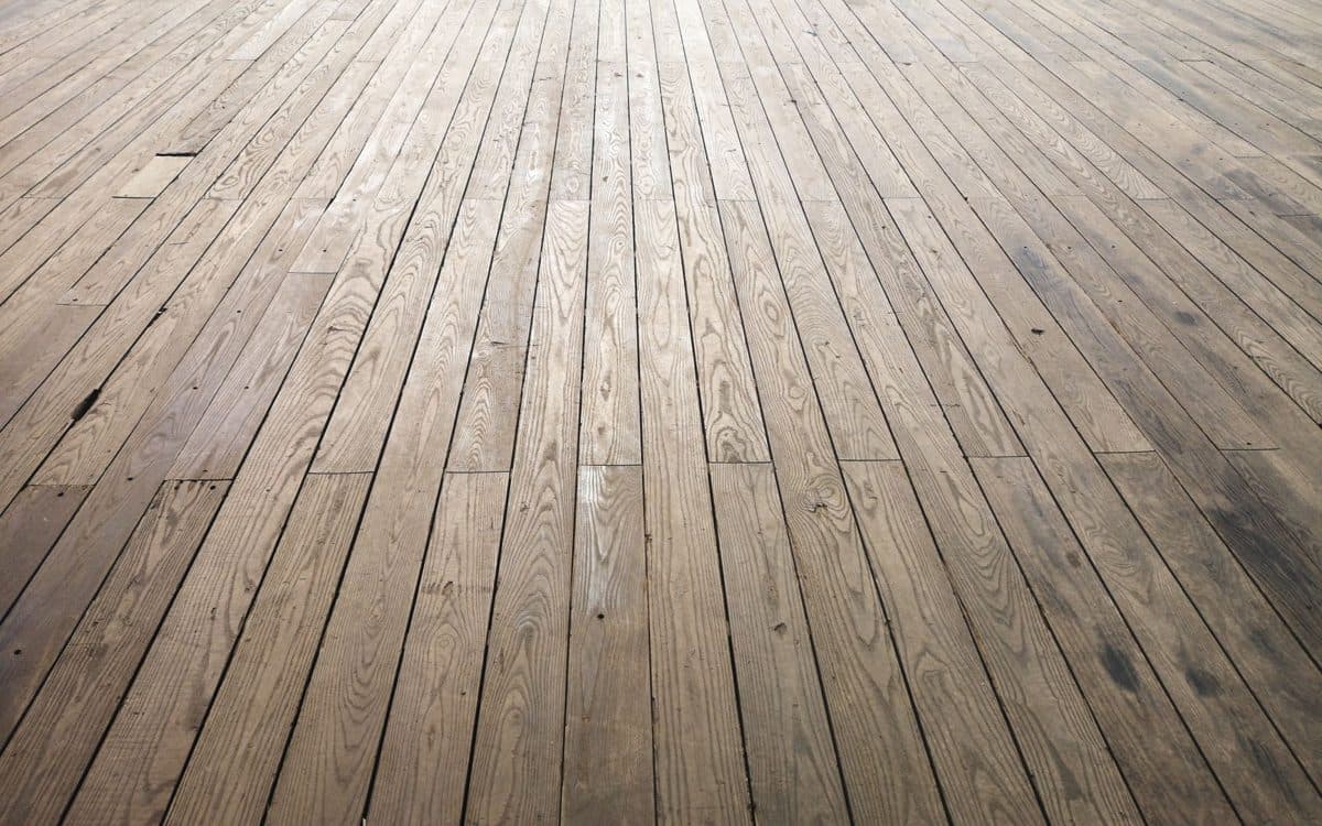 Sableuse professionnelle sur un plancher de bois franc partiellement sablé dans un appartement montréalais